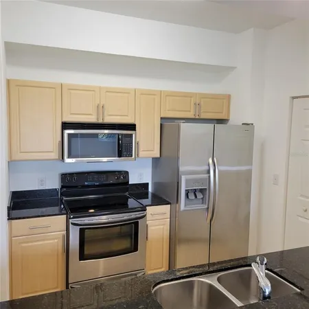 a kitchen with a refrigerator sink and stove
