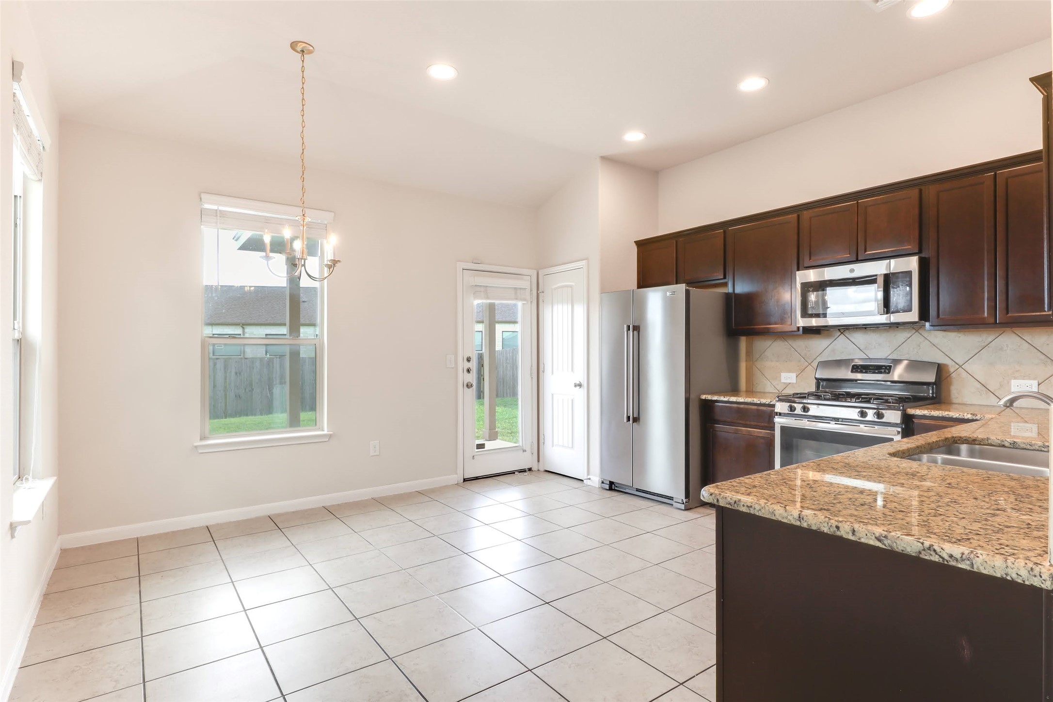 18705 Moreto Loop Pflugerville, TX 78660 - Photo 7 of 21 A well-equipped kitchen and dining area provides direct access to the private yard.
