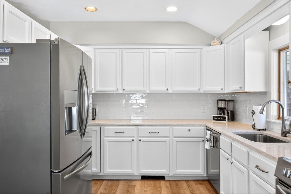 40 Shore Road Dennis, MA 02670 - Photo 13 of 34 a kitchen with stainless steel appliances white cabinets and a refrigerator