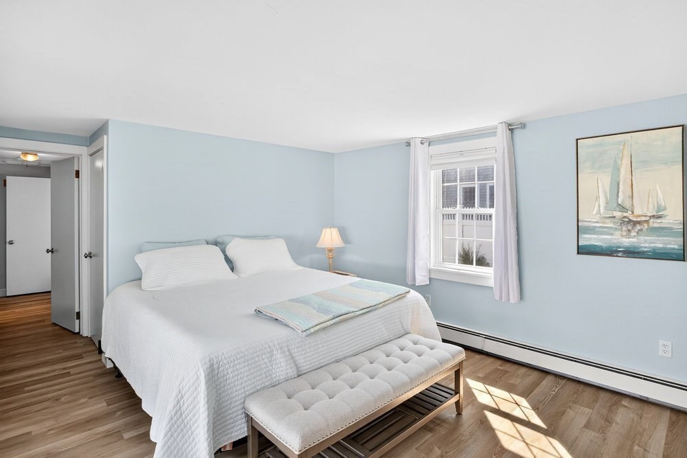 40 Shore Road Dennis, MA 02670 - Photo 15 of 34 a bedroom with a bed and wooden floor