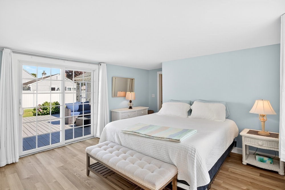 40 Shore Road Dennis, MA 02670 - Photo 16 of 34 a bedroom with a bed and wooden floor