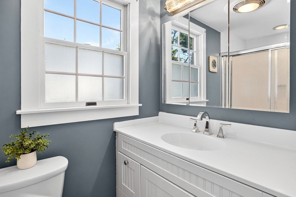 40 Shore Road Dennis, MA 02670 - Photo 18 of 34 a bathroom with a sink and a mirror