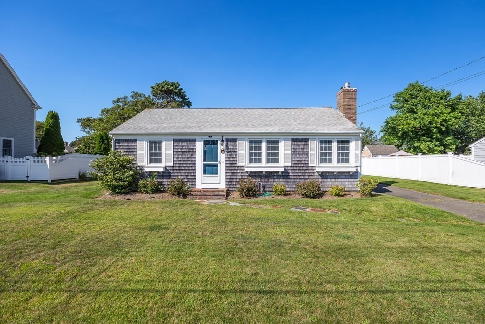 40 Shore Road Dennis, MA 02670 - Photo 2 of 34 a front view of a house with a yard