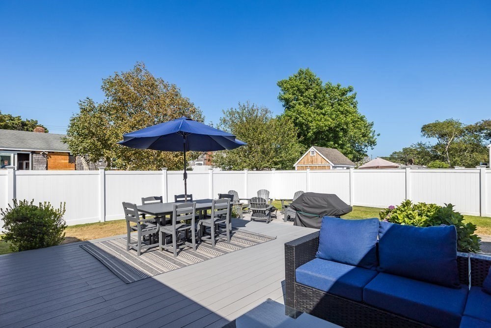 40 Shore Road Dennis, MA 02670 - Photo 23 of 34 a view of a chairs and table in patio with a fire pit