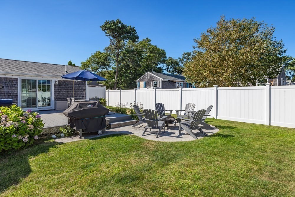 40 Shore Road Dennis, MA 02670 - Photo 28 of 34 a view of a chair and table in backyard of the house