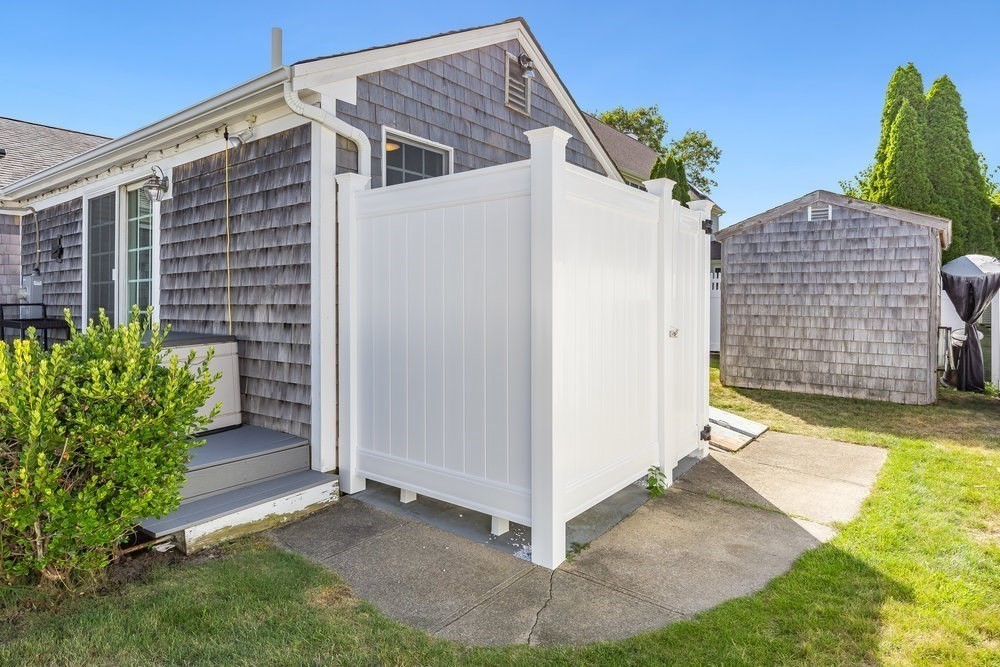 40 Shore Road Dennis, MA 02670 - Photo 29 of 34 a side view of a house with a yard