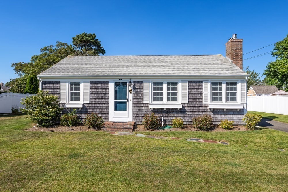 40 Shore Road Dennis, MA 02670 - Photo 3 of 34 a front view of a house with a yard