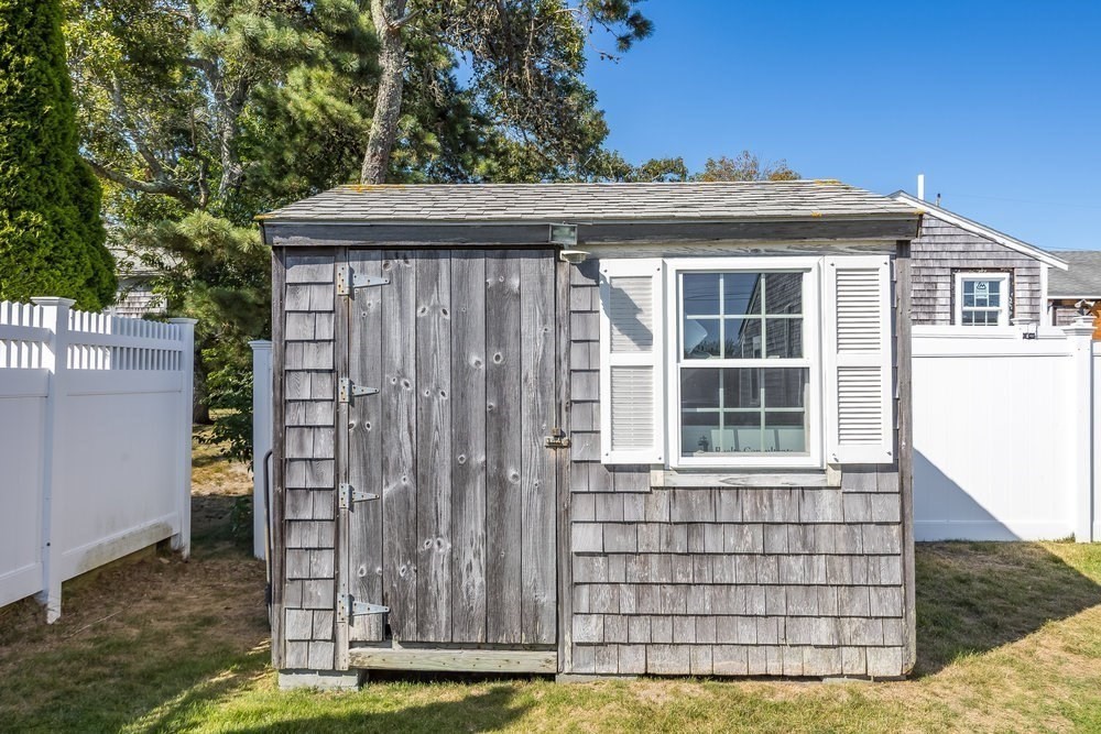 40 Shore Road Dennis, MA 02670 - Photo 31 of 34 a front view of a house with a garden