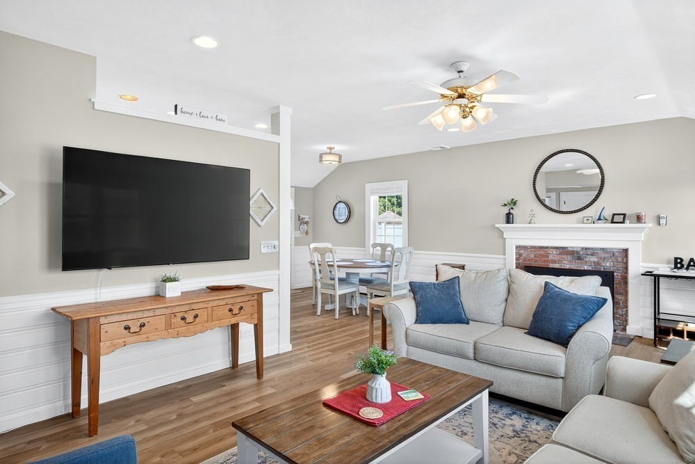 40 Shore Road Dennis, MA 02670 - Photo 8 of 34 a living room with furniture a flat screen tv and a fireplace