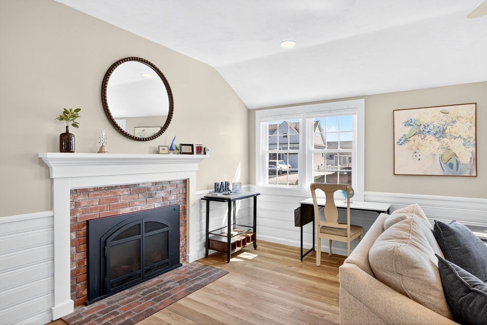 40 Shore Road Dennis, MA 02670 - Photo 9 of 34 a living room with furniture a window and a fireplace