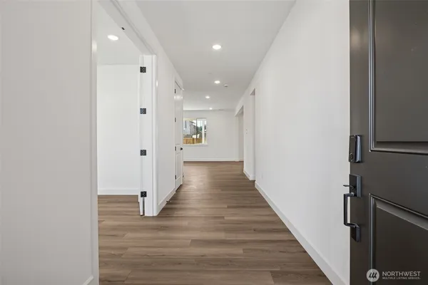 a view of a hallway with wooden floor