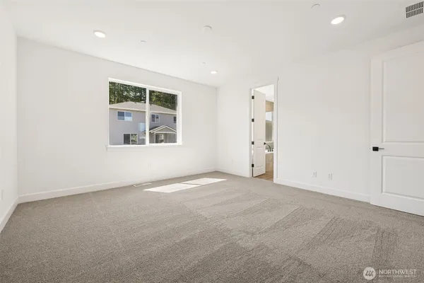 an empty room with a window and closet