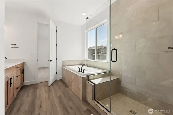 a bathroom with a tub sink and mirror