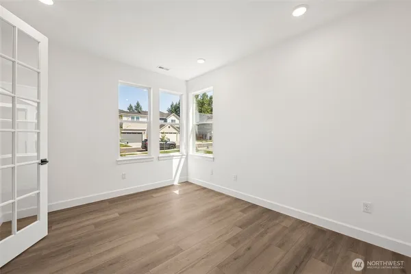 wooden floor in an empty room with a window