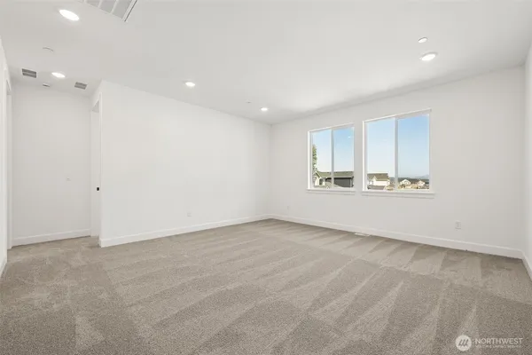 wooden floor in an empty room with a kitchen