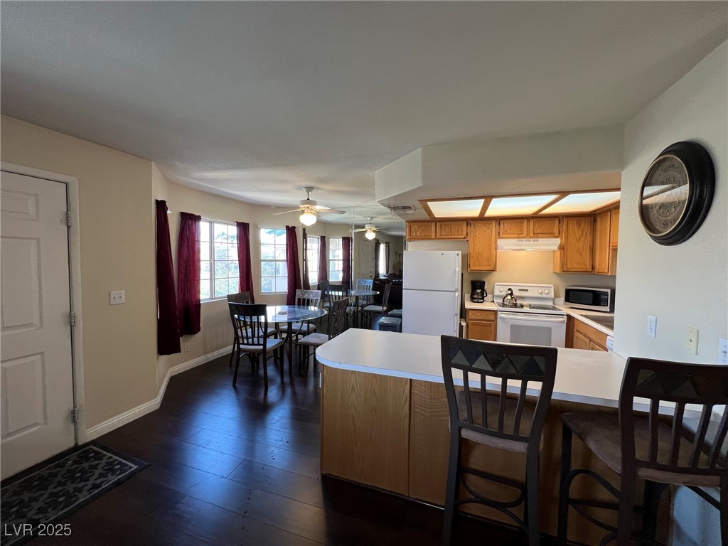 8410 Eldora Avenue, Unit 2020 Las Vegas, NV 89117 - Photo 3 of 10 Kitchen featuring light countertops, a peninsula,