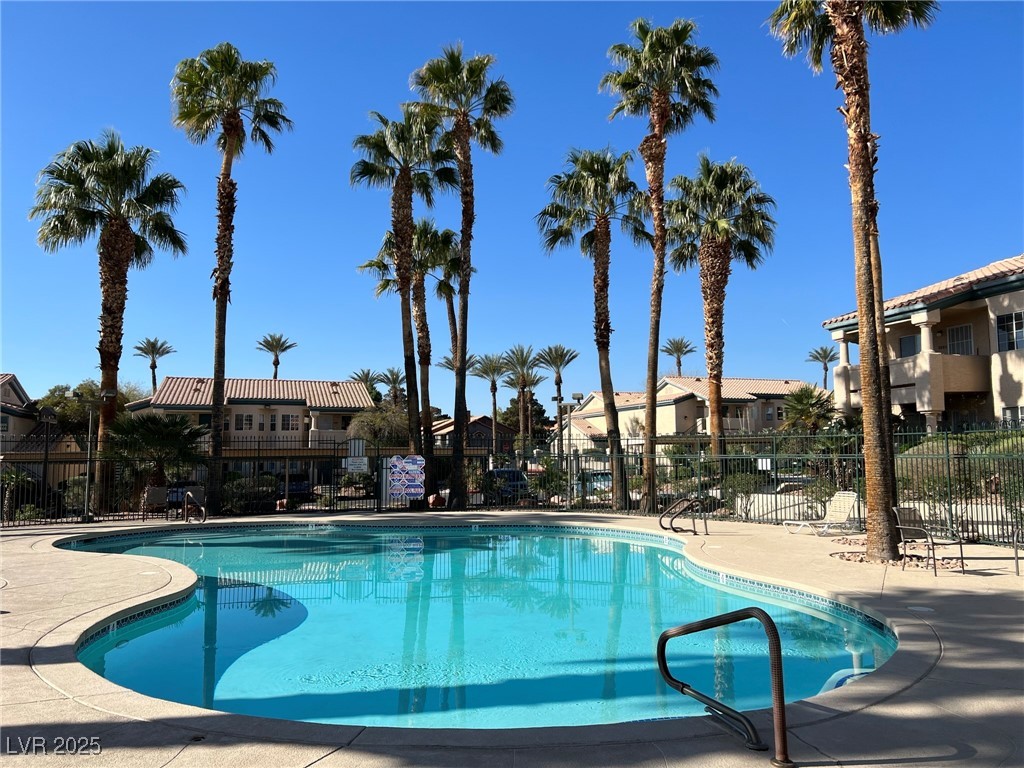 8410 Eldora Avenue, Unit 2020 Las Vegas, NV 89117 - Photo 8 of 10 Community pool featuring a residential view, fence