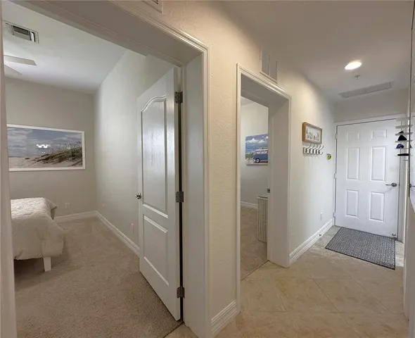 a view of an empty room and a bathroom