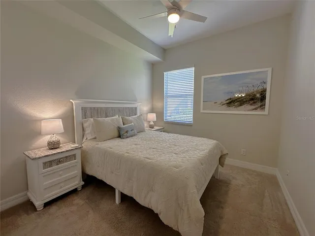 a bed sitting in a bedroom next to a window