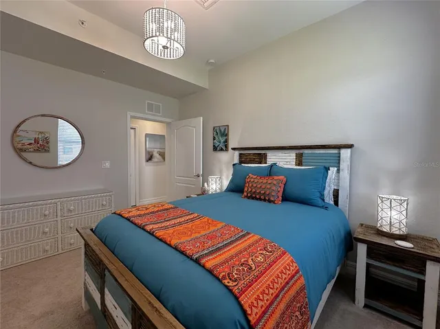 a bedroom with a bed and a table