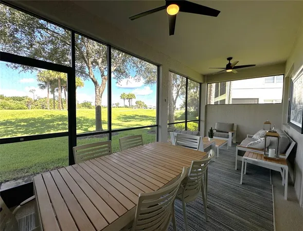a view of a patio with table and chairs floor to ceiling window with wooden floor