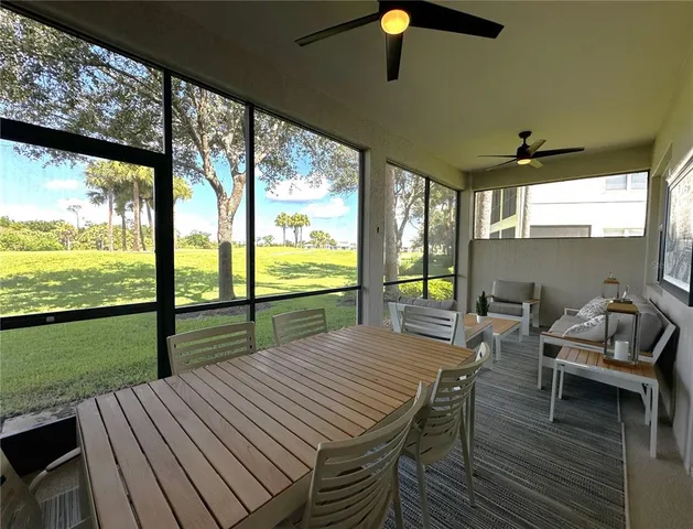 a view of a patio with table and chairs floor to ceiling window with wooden floor