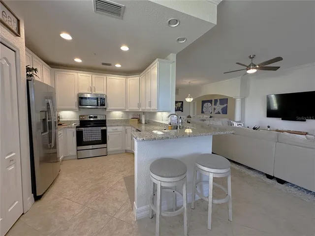 a kitchen with kitchen island appliances cabinets and furniture