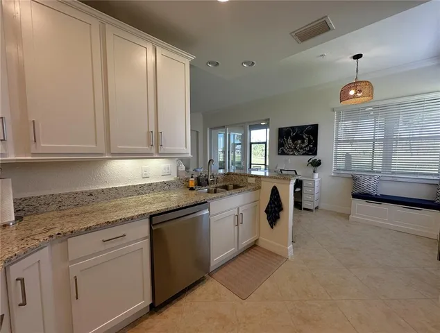 a kitchen with stainless steel appliances granite countertop a sink a stove and cabinets
