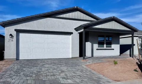 a front view of a house with barbeque and garage