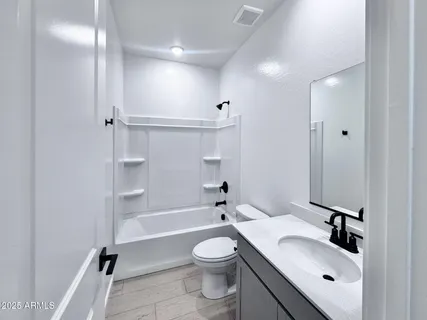 a kitchen with stainless steel appliances granite countertop a sink and a stove top oven