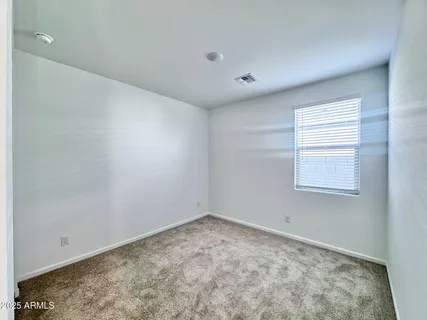 a large kitchen with granite countertop a large counter top stainless steel appliances and cabinets