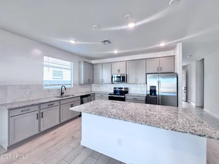 a view of an empty room and wooden floor