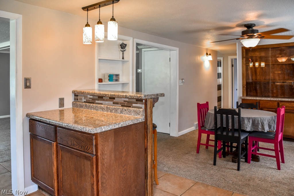 3703 Johnson Road Norton, OH 44203 - Photo 6 of 24 Peninsula with a breakfast bar adds excellent counterspace.