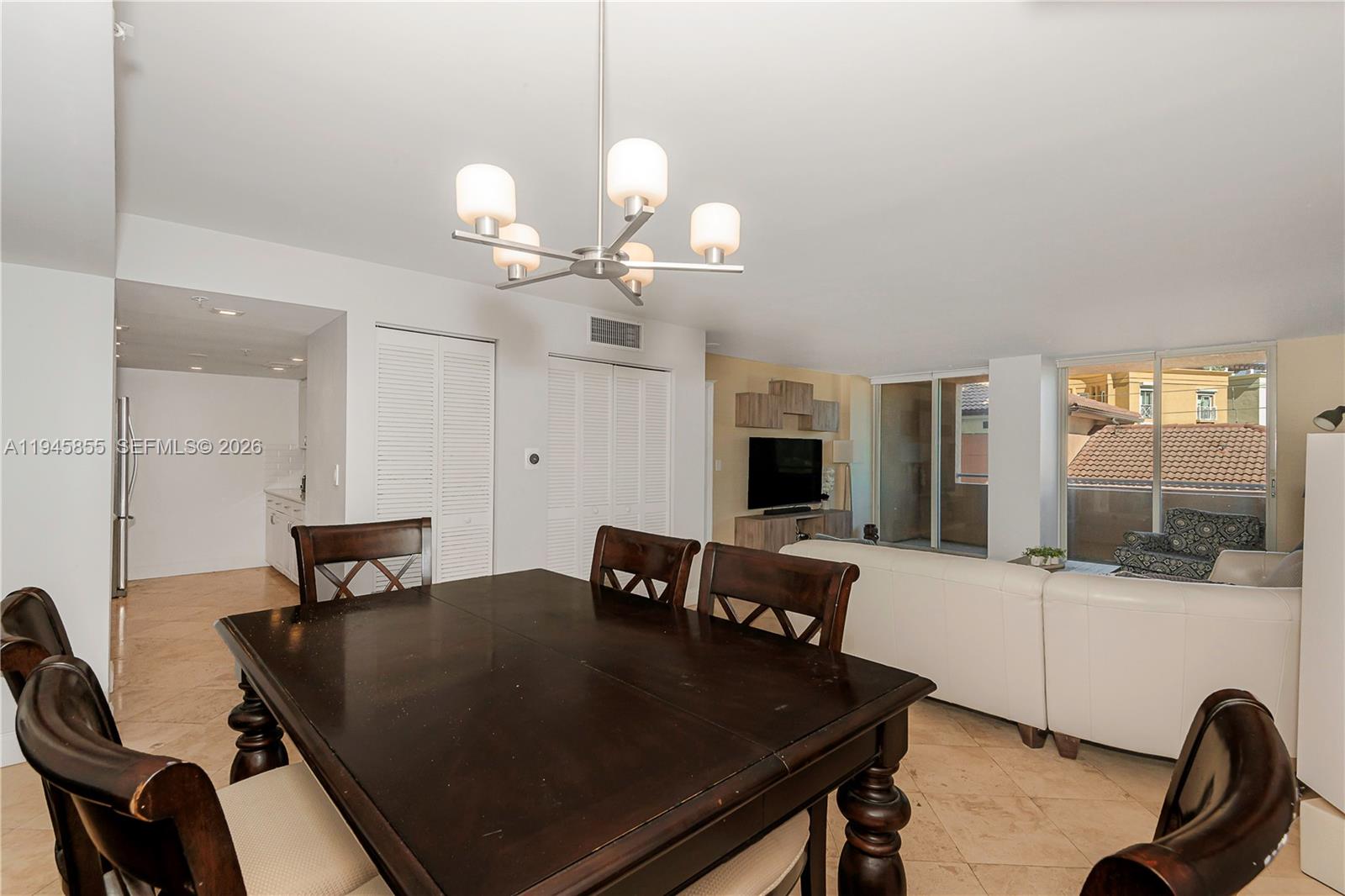 90 Alton Road, Unit 301 Miami Beach, FL 33139 - Photo 11 of 30 a view of a dining room with furniture and wooden floor