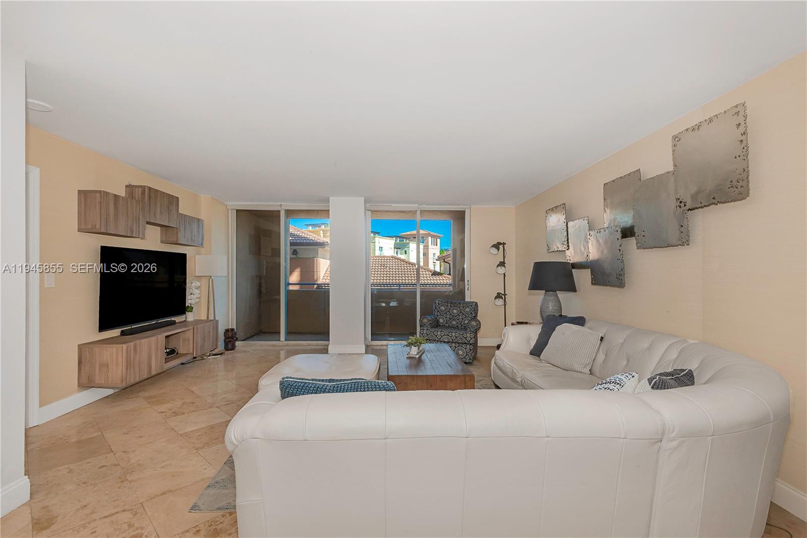 90 Alton Road, Unit 301 Miami Beach, FL 33139 - Photo 14 of 30 a living room with furniture and a flat screen tv