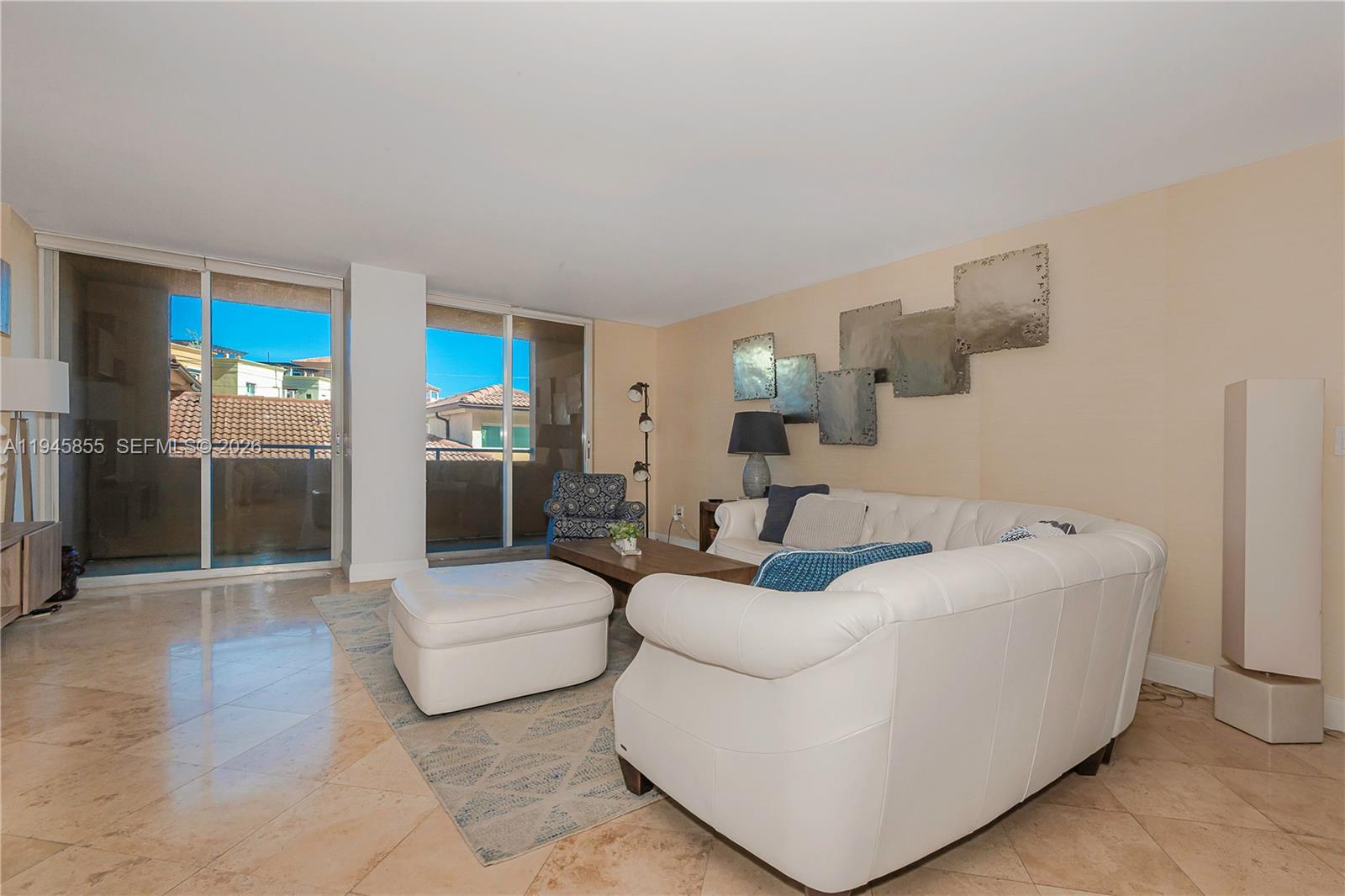 90 Alton Road, Unit 301 Miami Beach, FL 33139 - Photo 15 of 30 a living room with furniture and a flat screen tv