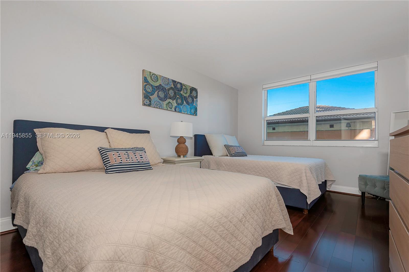 90 Alton Road, Unit 301 Miami Beach, FL 33139 - Photo 16 of 30 a bedroom with a large bed and a window