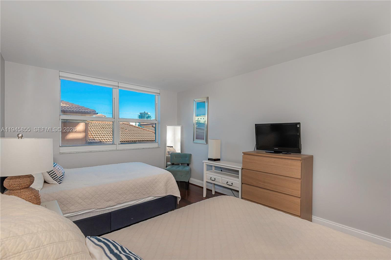 90 Alton Road, Unit 301 Miami Beach, FL 33139 - Photo 17 of 30 a bedroom with two beds and a television