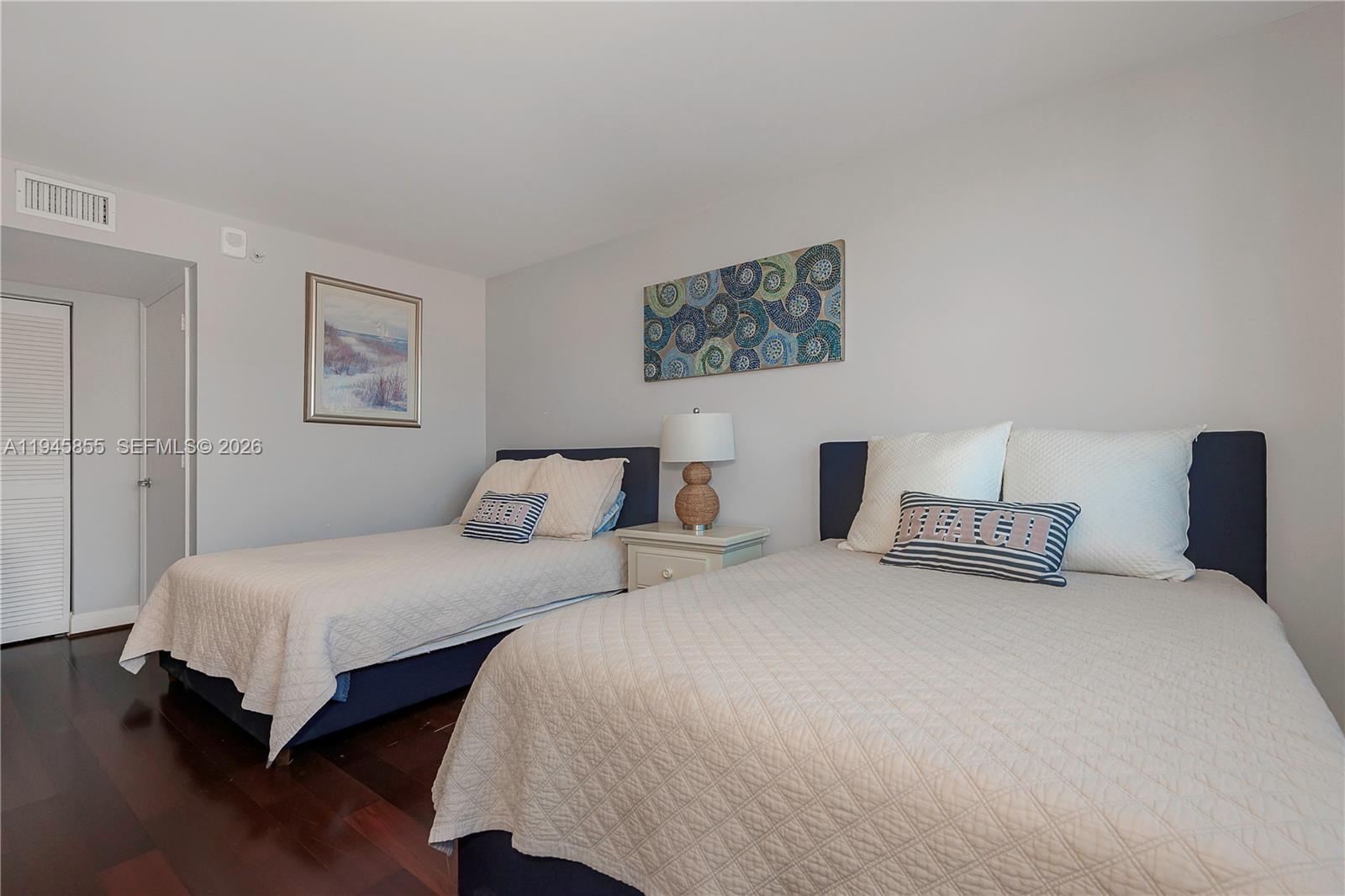 90 Alton Road, Unit 301 Miami Beach, FL 33139 - Photo 18 of 30 a bedroom with two beds and painting on the wall
