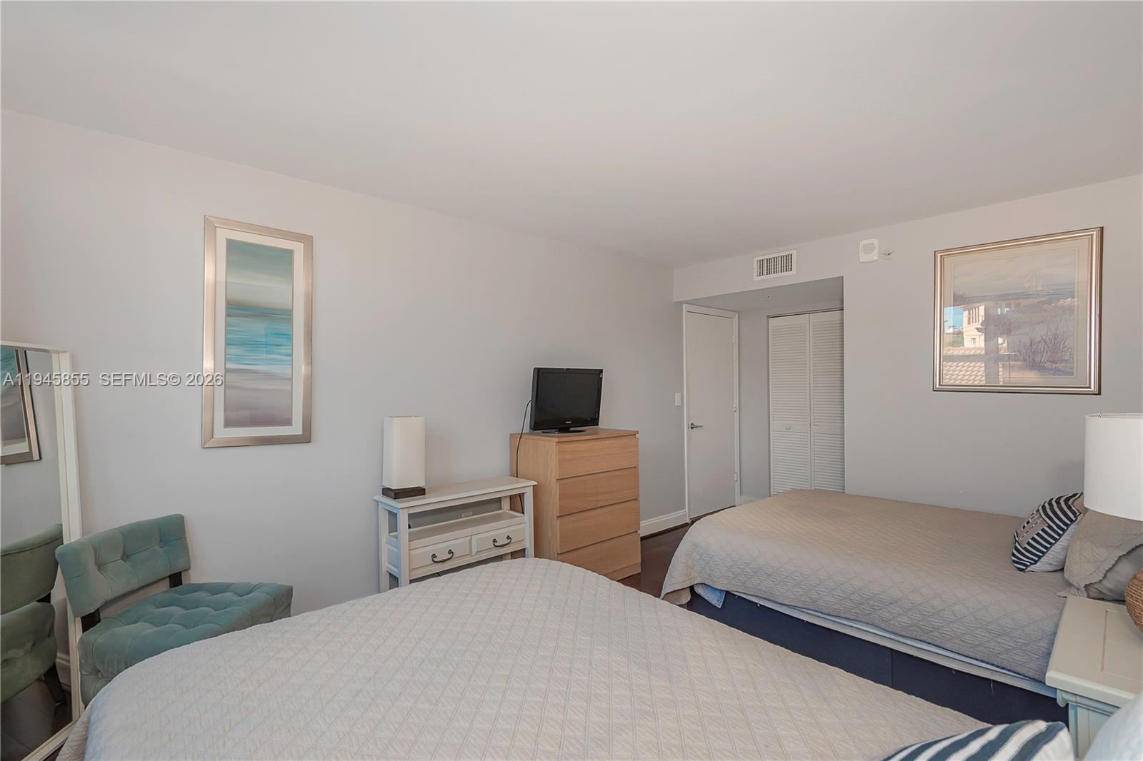 90 Alton Road, Unit 301 Miami Beach, FL 33139 - Photo 19 of 30 a bedroom with a bed and a television