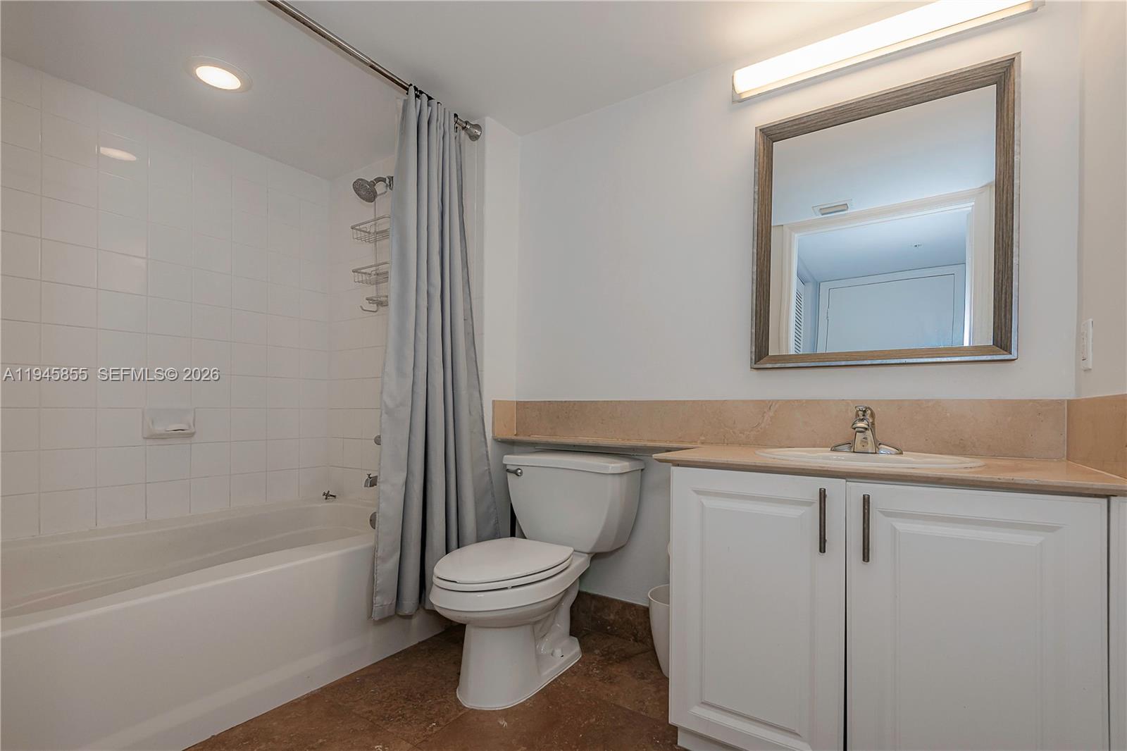 90 Alton Road, Unit 301 Miami Beach, FL 33139 - Photo 20 of 30 a bathroom with a toilet sink and mirror