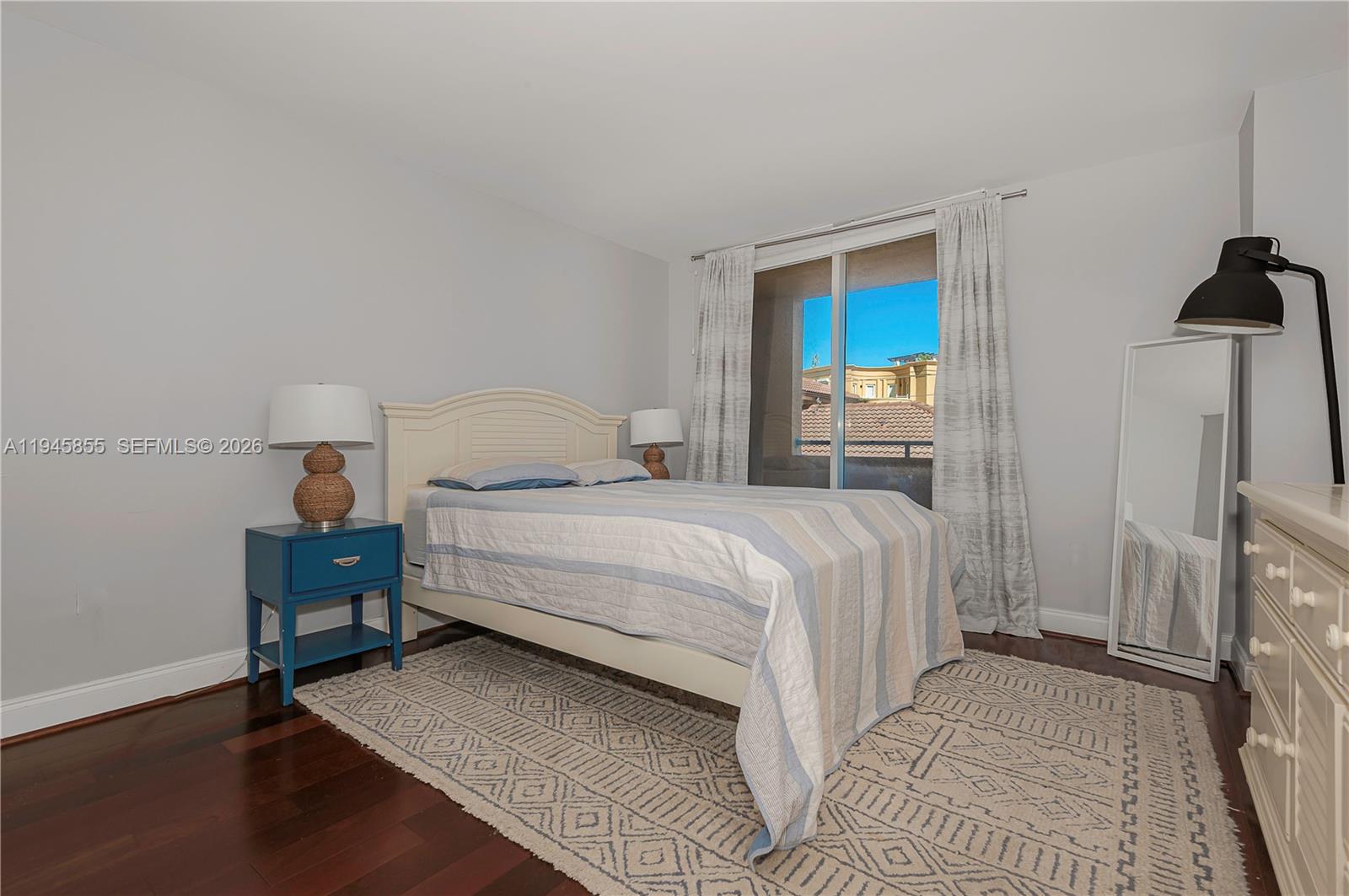 90 Alton Road, Unit 301 Miami Beach, FL 33139 - Photo 23 of 30 a bedroom with a bed and a view of bathroom