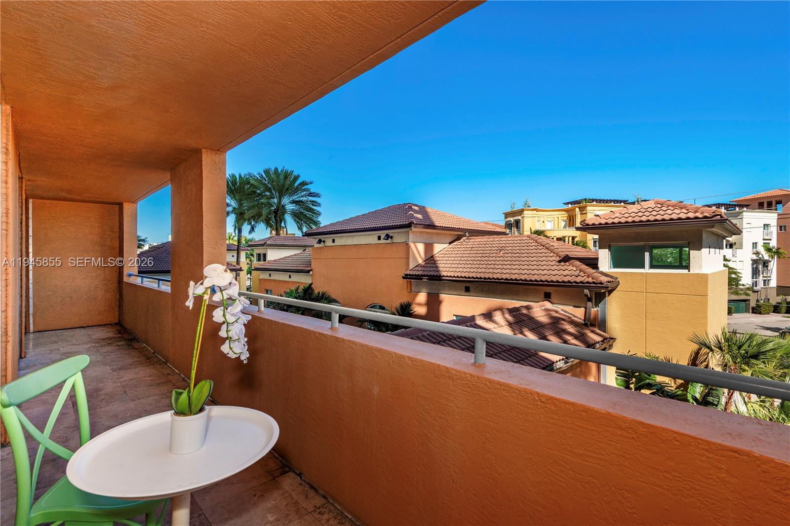 90 Alton Road, Unit 301 Miami Beach, FL 33139 - Photo 7 of 30 a balcony with table and chairs
