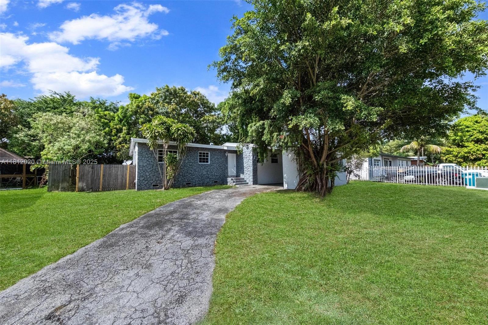 a view of a yard with a tree