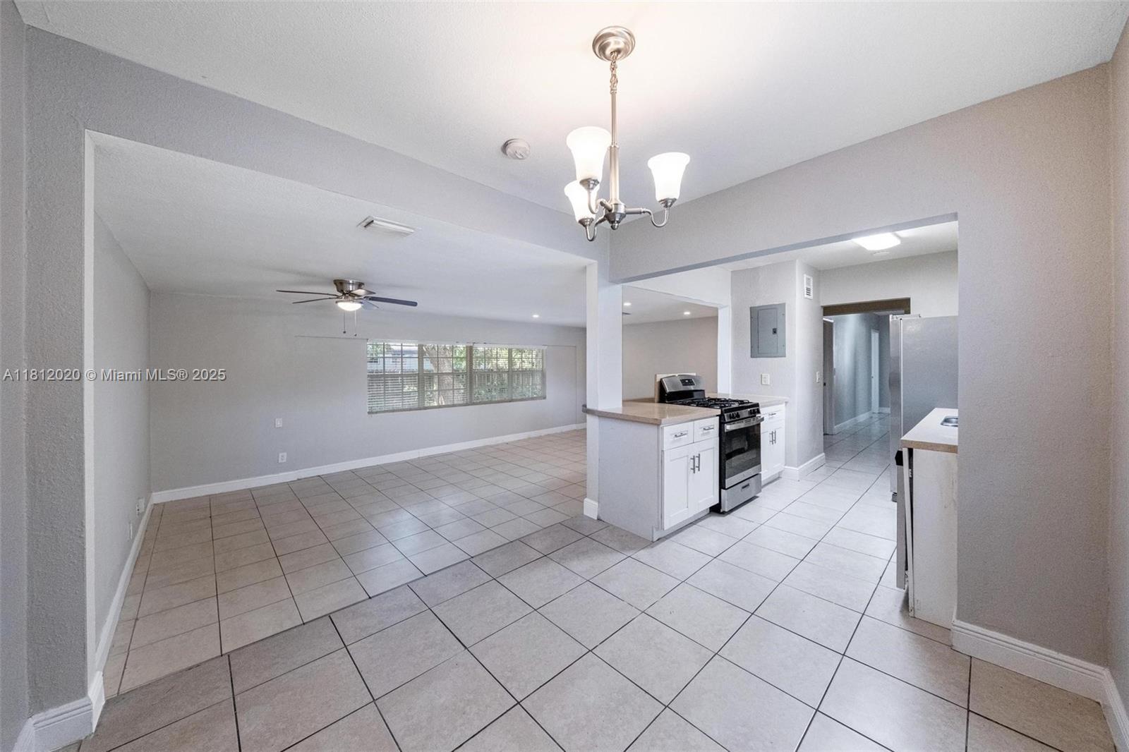 725 Northeast 178th Street Miami, FL 33162 - Photo 18 of 44 a view of a kitchen with a sink and refrigerator