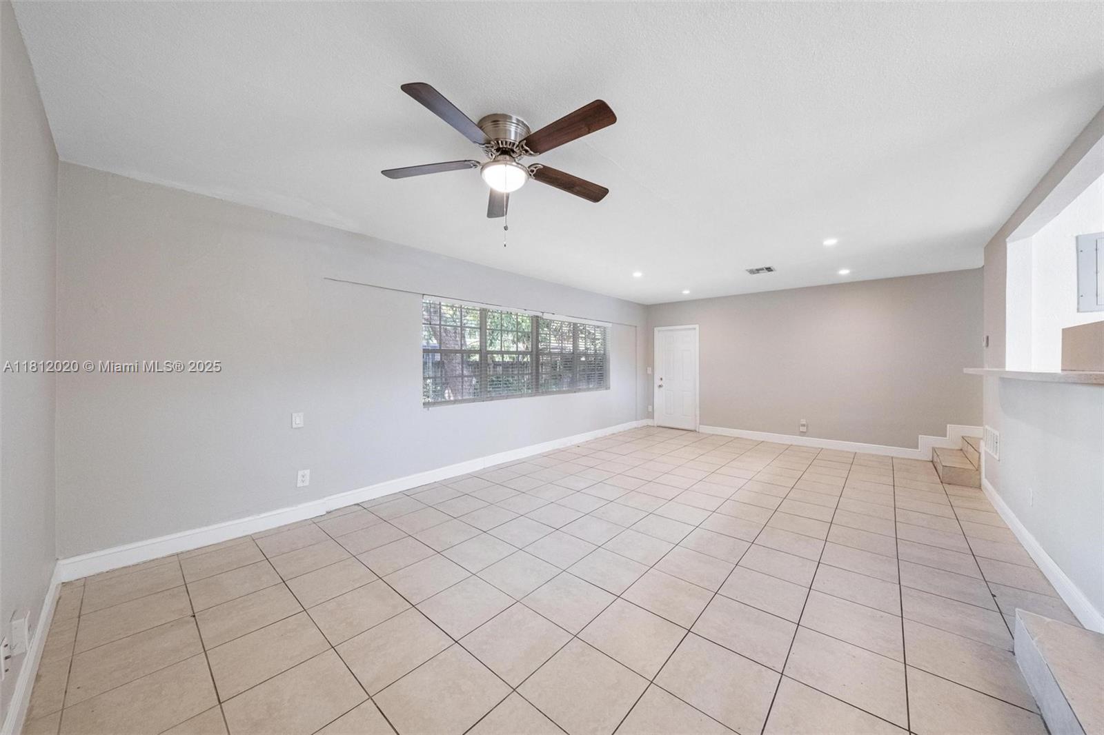 725 Northeast 178th Street Miami, FL 33162 - Photo 19 of 44 a view of an empty room and window