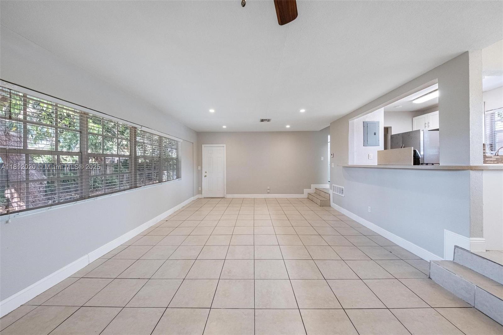 725 Northeast 178th Street Miami, FL 33162 - Photo 20 of 44 a view of an empty room with a window