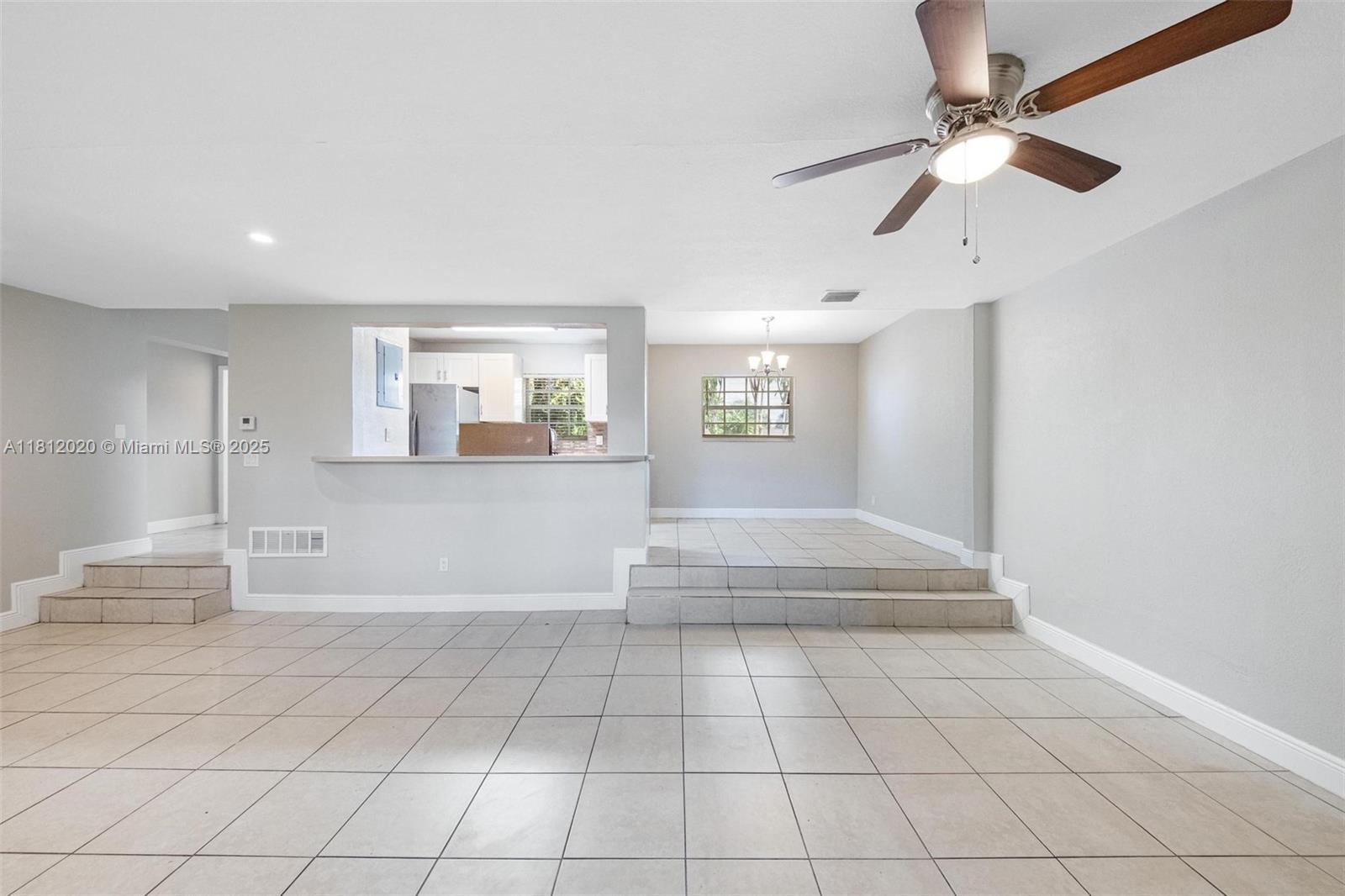 725 Northeast 178th Street Miami, FL 33162 - Photo 22 of 44 a view of an empty room with a window