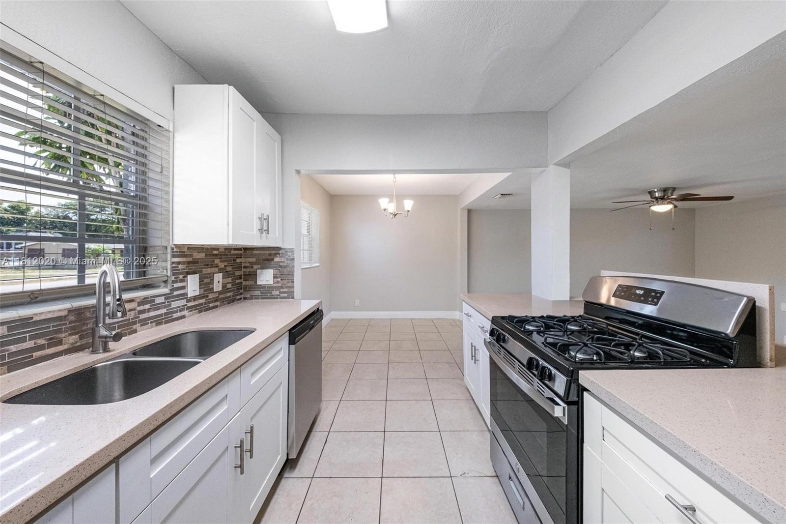 725 Northeast 178th Street Miami, FL 33162 - Photo 27 of 44 a kitchen that has a sink and a stove