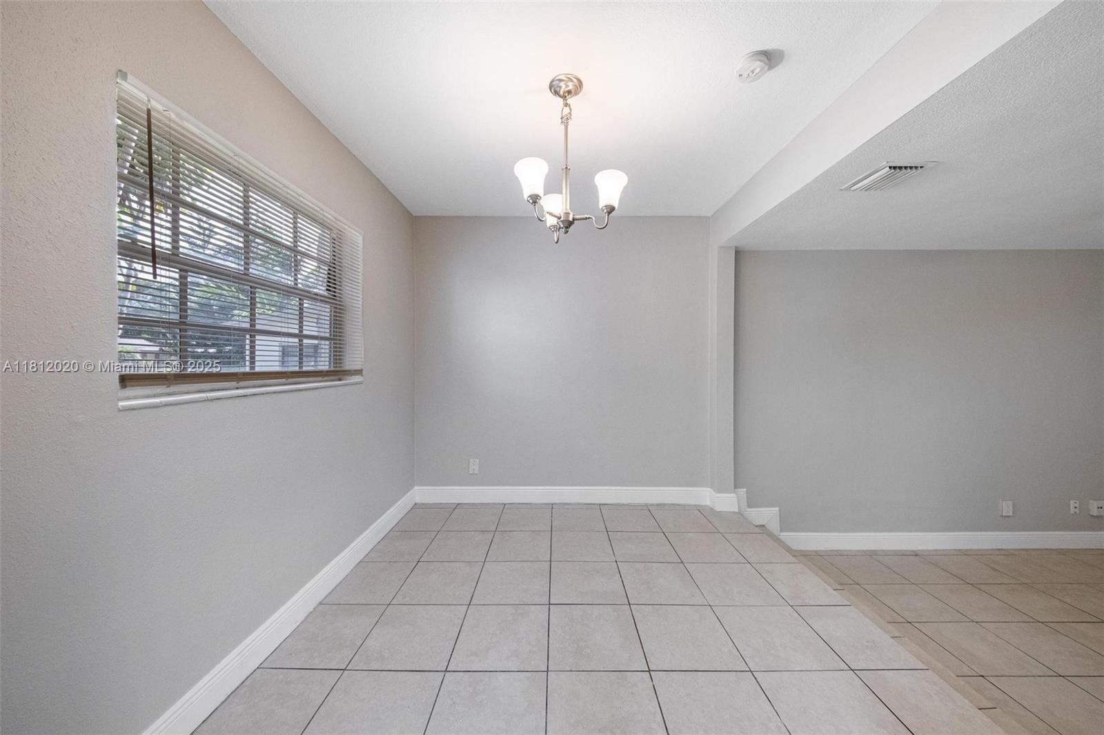 725 Northeast 178th Street Miami, FL 33162 - Photo 30 of 44 a view of an empty room with a window